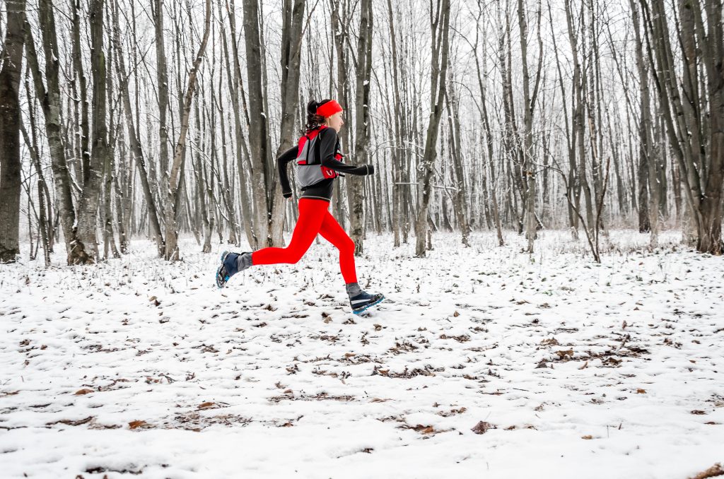 Woman running in snow.
